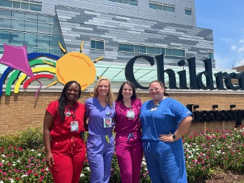 group of four residents standing in front of Children's of Mississippi